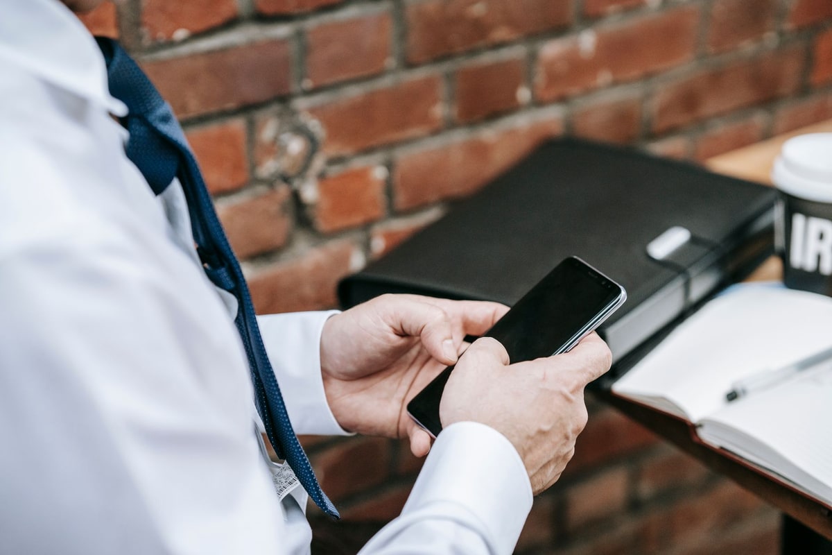 Business owner checking scheduled social media content on a smartphone