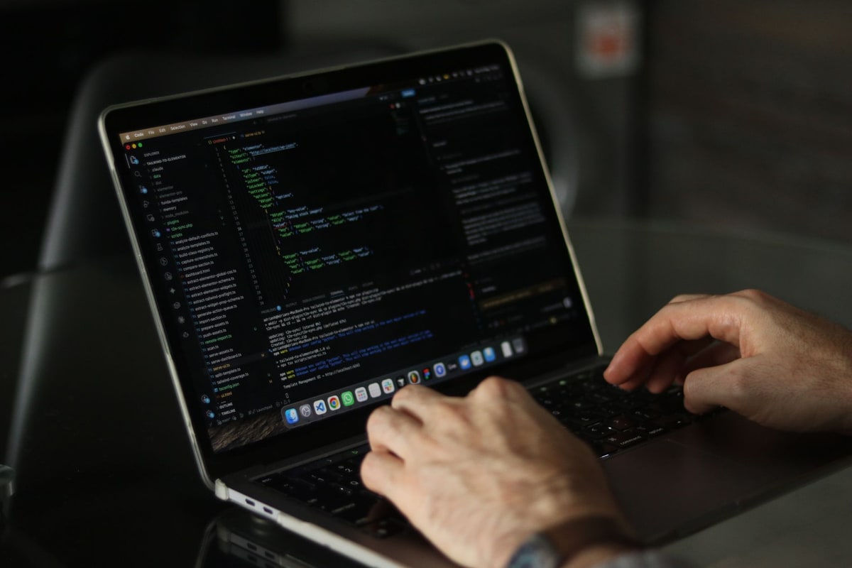 Developer reviewing custom automation logic on a laptop