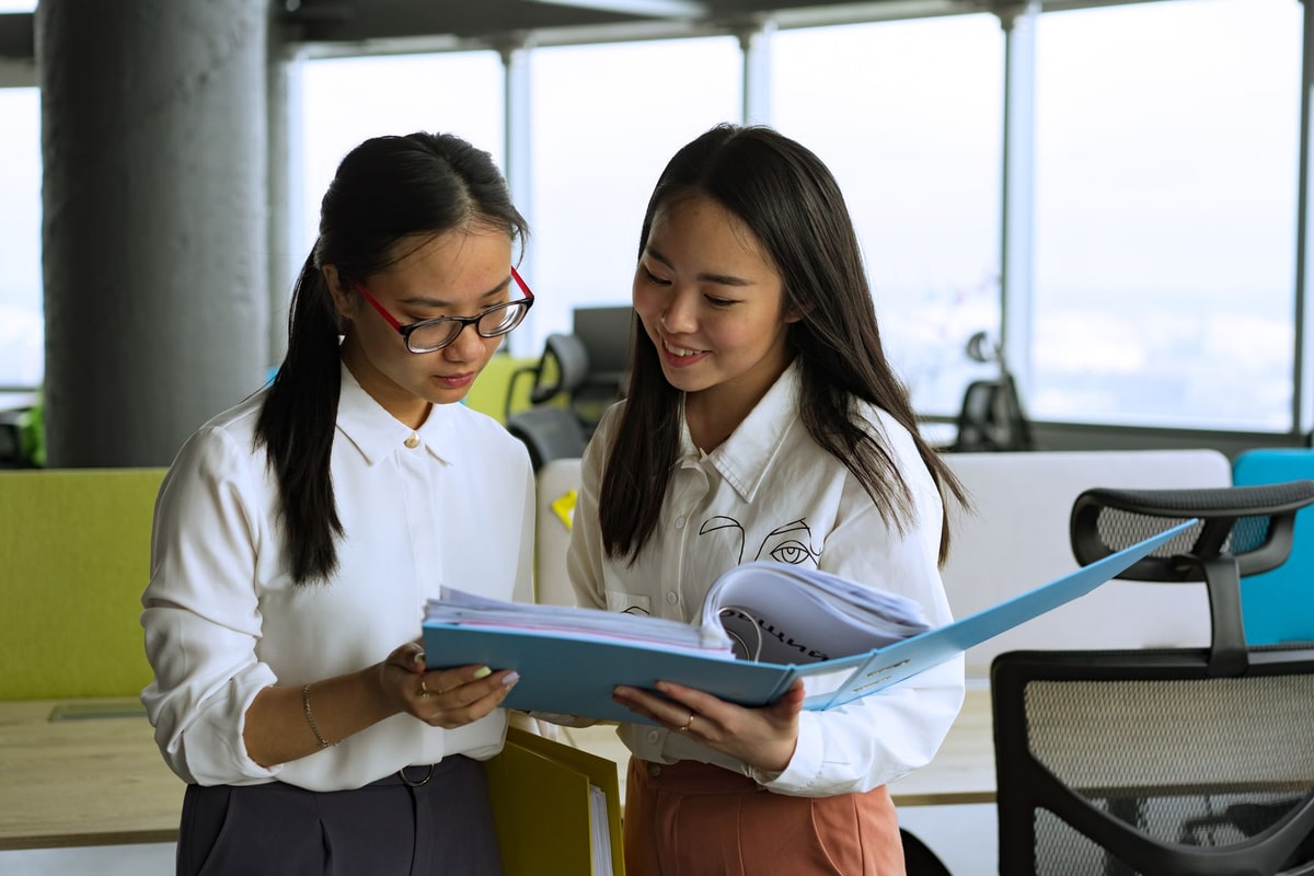 Sales team reviewing approval documents together