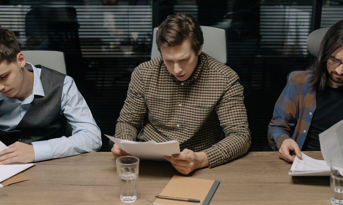 Sales team reviewing an automated proposal workflow on a laptop