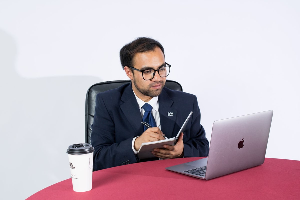 Operations manager reviewing integration notes beside a laptop