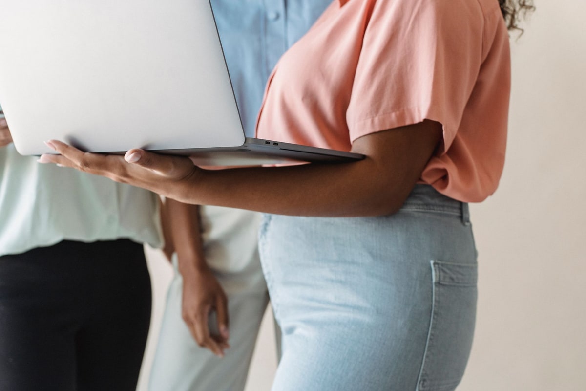 Team checking records together on a laptop