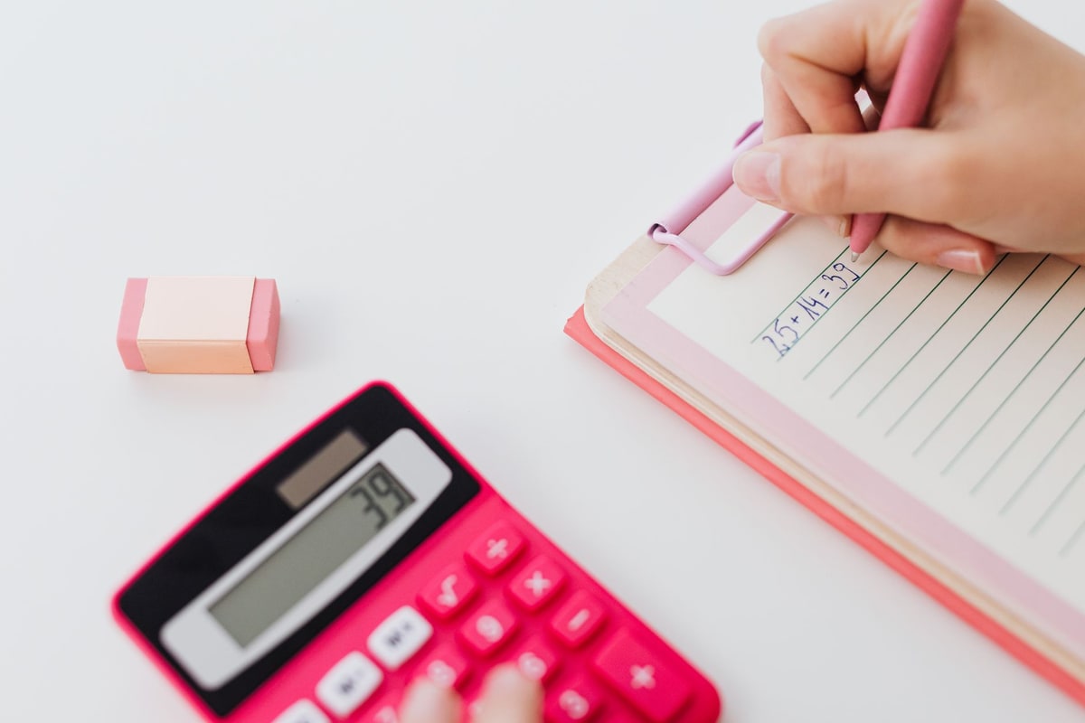 Calculator and notebook used to total monthly service costs