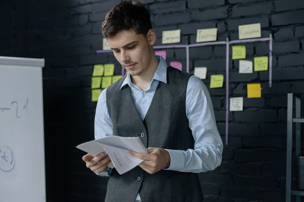 Owner reviewing a list of past customers at an office desk